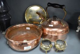 A selection of antique copper and brass wares including solid cast brass trivet, stove kettle and