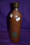 An unusual copper and brass flask, of traditional form, the soldered brass terminal with screw-off