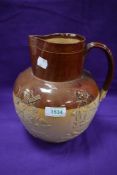 An early 20th century Doulton Lambeth harvest scene jug 22cm tall, small chip to rim.