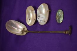 An early 20th century table salt serving set in mother of pearl with a silver and carved shell