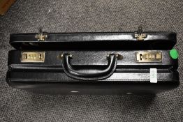 A mens black lockable attaché case.