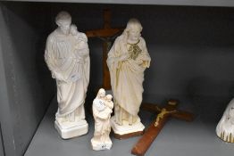 Three religious figurines and two wooden crucifixes, including French Mary and Joseph, marked