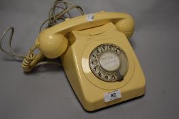 A vintage cream plastic Rotary phone.