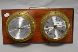 A mid century brass clock and barometer duo mounted on wooden plaque.
