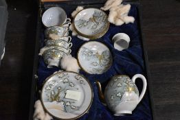 An early 20th century cased Chinese porcelain tea set decorated with birds and foliage.