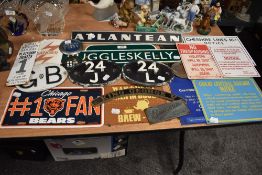A selection of tin plate, cast signs and car badges