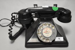 An early plastic rotary dial telephone.