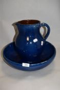 An earthenware jug and basin set, having blue and brown glaze, AF.