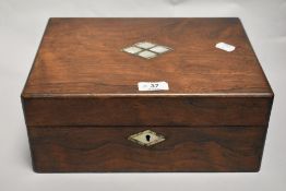 A Victorian sewing case having Rose wood case with a well fitted interior and mother of pearl