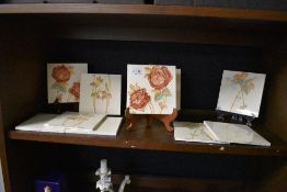 Two sets of early 20th century tiles hand painted with scenes of country garden roses.