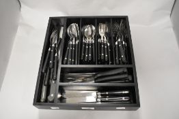 A cutlery tray of modern stainless steel and plastic handled cutlery.