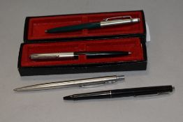 Four ballpoint pens 3 Parker and a Papermate. Two Parkers in boxes, some refills required
