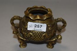 An antique Chinese cast bronze censor or Koro in the form of a lucky money pot on tripod base as