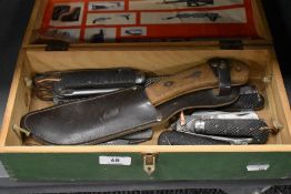 A box of vintage knives, multi tools, including Military issue.