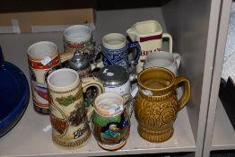 A selection of collectable steins, tankards and a Bells whisky water jug.