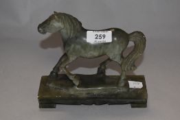 A 20th century carved natural green stone horse on plinth, AF, (loose from plinth).