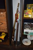 A reproduction ceremonial sword having decorative scabbard and a replica rifle, having carved wooden