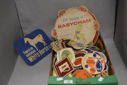 A collection of vintage beer mats, various brands and eras.
