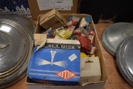 A box of parts and spares, most boxed, including spark plugs, head lamp, bulbs etc.