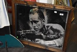 A framed mirror, of Arnold Schwarzenegger interest.