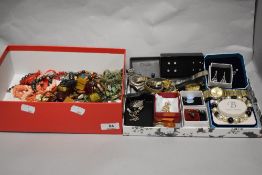 An assortment of costume jewellery and watches.