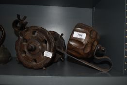 A carved wood and metal wine bottle holder in the form of a canon.