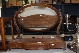 A large sized Victorian toilet mirror having mahogany frame with carved supports and formed feet.