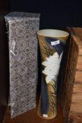 A large Japanese porcelain vase of slender trumpet form decorated with exotic flowers with