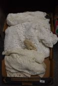 A box of finely crotched cloths, throws and mats.