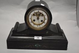 A Victorian black marble mantel clock, having etched scroll detail and green natural stone inset