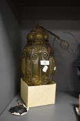 An unusual hand blown 19th century glass lantern, having scrolled metal caging and removable lid,