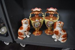 A pair of Staffordshire dogs and a pair of 20th century urns, having classical scenes of groups of