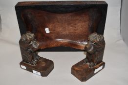 A carved wood tray or bowl and a pair of 1930s carved dog book ends.