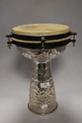 A 20th century Darbuka Tabla percussion drum with an embossed metal work body.