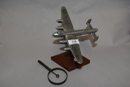 A mid century metal Lancaster Bomber on mahogany stand, having painted underside.