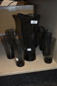 A stylised smoked glass lemonade set; comprising tall jug and six glasses.