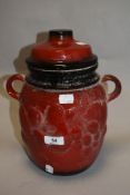 A retro Rumtopf having red glaze.