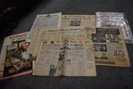 A box of vintage ephemera, including adverts, newspapers and magazines.