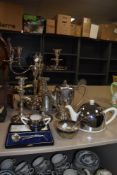 A mixed lot of plated ware, amongst which are candlesticks, boxed childrens spoon and pusher, and