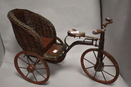A miniature wicker and metal vintage style tricycle.
