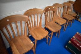 A set of six beech rail back kitchen chairs