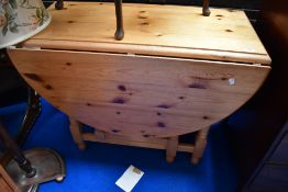 A vintage pine gateleg dining table