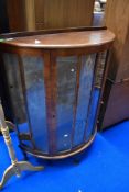 An early 20th Century walnut bow fronted china cabinet