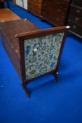 An Edwardian mahogany firescreen having tapestry panel
