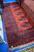 A traditional persian style rug, having red shades ground