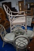 A bentwood and cane conservatory style dining suite comprising glass top table and five chairs