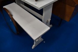 A vintage painted rustic kitchen table and single bench