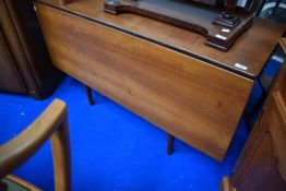 A vintage teak dining table with single drop leaf