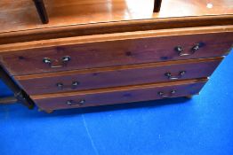 A vintage pine bedroom chest of three long drawers