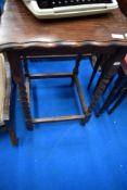 An early 20th Century oak occasional table having twist frame